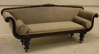 A Victorian mahogany framed scroll arm sofa on baluster turned and ringed supports to brass caps