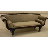 A Victorian mahogany framed scroll arm sofa on baluster turned and ringed supports to brass caps