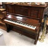 A rosewood cased upright piano, the iron framed overstrung movement by Winkelmann,