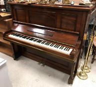 A rosewood cased upright piano, the iron framed overstrung movement by Winkelmann,