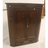 A George III North Country English oak and inlaid hanging corner cupboard,