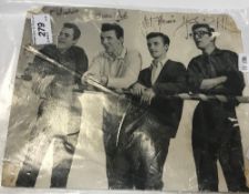 An unframed black and white photograph of The Shadows signed by all four members,