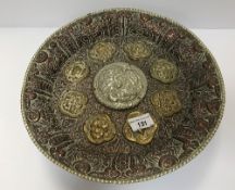 An Islamic copper, brass and white metal pedestal dish with high relief and medallion decoration,