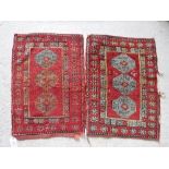 A Persian rug with repeating elephant foot medallions on a red ground within a stylised flower head