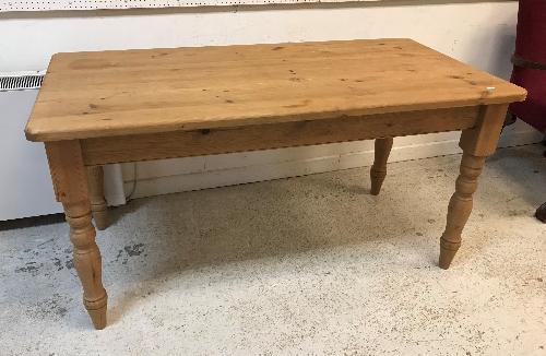 A modern pine farmhouse kitchen table on turned legs in the Victorian manner,