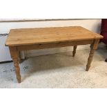 A modern pine farmhouse kitchen table on turned legs in the Victorian manner,