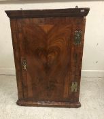 An early 18th Century walnut veneered hanging corner cupboard,