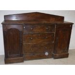 A Victorian stained pine break front sideboard with raised back over three central drawers flanked