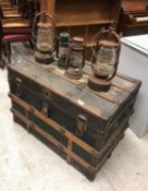 A vintage trunk and four hurricane lamps