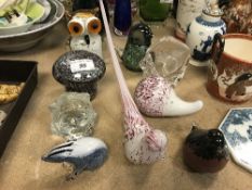 A collection of glass paperweights to include a Murano glass Owl, Mdina bird, Mdina mushroom,