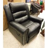 A modern black leather upholstered scroll arm reclining chair with studded decoration to the scroll