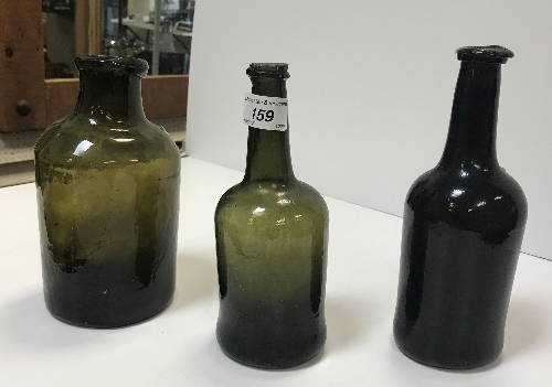 A selection of three 19th Century green glass bottles, the tallest approx 21.