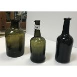 A selection of three 19th Century green glass bottles, the tallest approx 21.