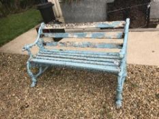 A Victorian cast iron and slatted wooden bench,