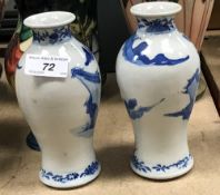 A pair of 19th Century Chinese baluster shaped vases decorated with warriors on horseback,