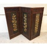 A Victorian walnut three fold dwarf screen in the Aesthetic taste with all-over carved flower head