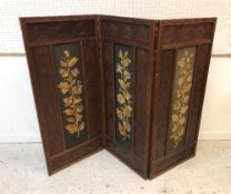 A Victorian walnut three fold dwarf screen in the Aesthetic taste with all-over carved flower head