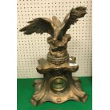 A circa 1900 gold painted spelter mantel clock with spreadeagle surmount (modern movement),