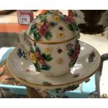 A circa 1900 Meissen chocolate cup with high relief floral and hand-painted decoration,