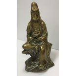 A Chinese bronze figure of Guan Yin seated with scroll in her hands,