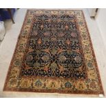 A Persian rug, the central panel set with stylised foliate decoration on a dark blue ground,