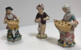 A pair of Höchst miniature figures as lady and gentleman with basket or pot pourri on a floral