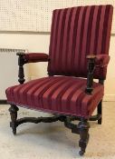 A Victorian upholstered open arm hall chair, the arms on faceted tapering octagonal supports,