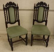 A set of six late Victorian carved oak dining chairs in the Carolean style,