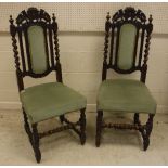 A set of six late Victorian carved oak dining chairs in the Carolean style,