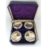 A set of four Victorian silver cauldron salts raised on three feet with floral decoration (Exeter