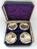 A set of four Victorian silver cauldron salts raised on three feet with floral decoration (Exeter