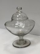 An early 19th Century leech jar on pedestal stand and circular foot with associated cover 23 cm