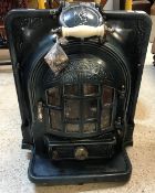 A French enamelled Antra fire or log burner with pierced decoration,