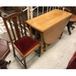 An oak oval gate-leg drop-leaf dining table and set of four oak dining chairs