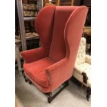 A 19th Century mahogany framed wingback chair on square moulded supports to casters (with