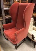 A 19th Century mahogany framed wingback chair on square moulded supports to casters (with