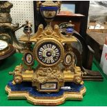 A 19th Century gilt spelter mantel clock with enamelled dial set with Roman numerals,