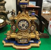 A 19th Century gilt spelter mantel clock with enamelled dial set with Roman numerals,