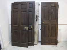 A collection of four various doors including a 19th Century pine exterior door with central lozenge