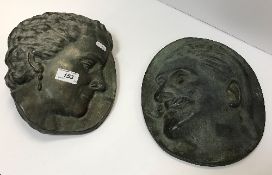 A pair of bronze plaques depicting a woman with ear-ring and man with moustache by Alice