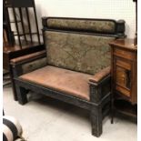 An unusual Victorian oak and inlaid settle with upholstered back panels and blind fretwork carved