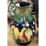 A William Moorcroft baluster shaped vase, leaf and berry pattern,