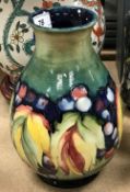 A William Moorcroft baluster shaped vase, leaf and berry pattern,