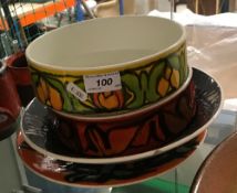 A collection of Poole pottery bowls, platters, etc.