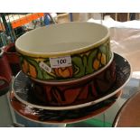 A collection of Poole pottery bowls, platters, etc.