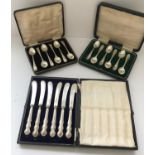 Two sets of cased silver teaspoons together with a cased set of silver butter knives. 5.