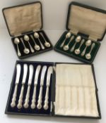 Two sets of cased silver teaspoons together with a cased set of silver butter knives. 5.