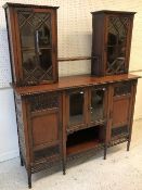 An Edwardian mahogany and blind fretwork decorated side cabinet with two glazed cabinets linked by