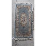 A Chinese superwash oval rug and another rectangular superwash rug,