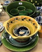 A collection of Continental pottery table wares to include a large green twin-handled serving bowl,